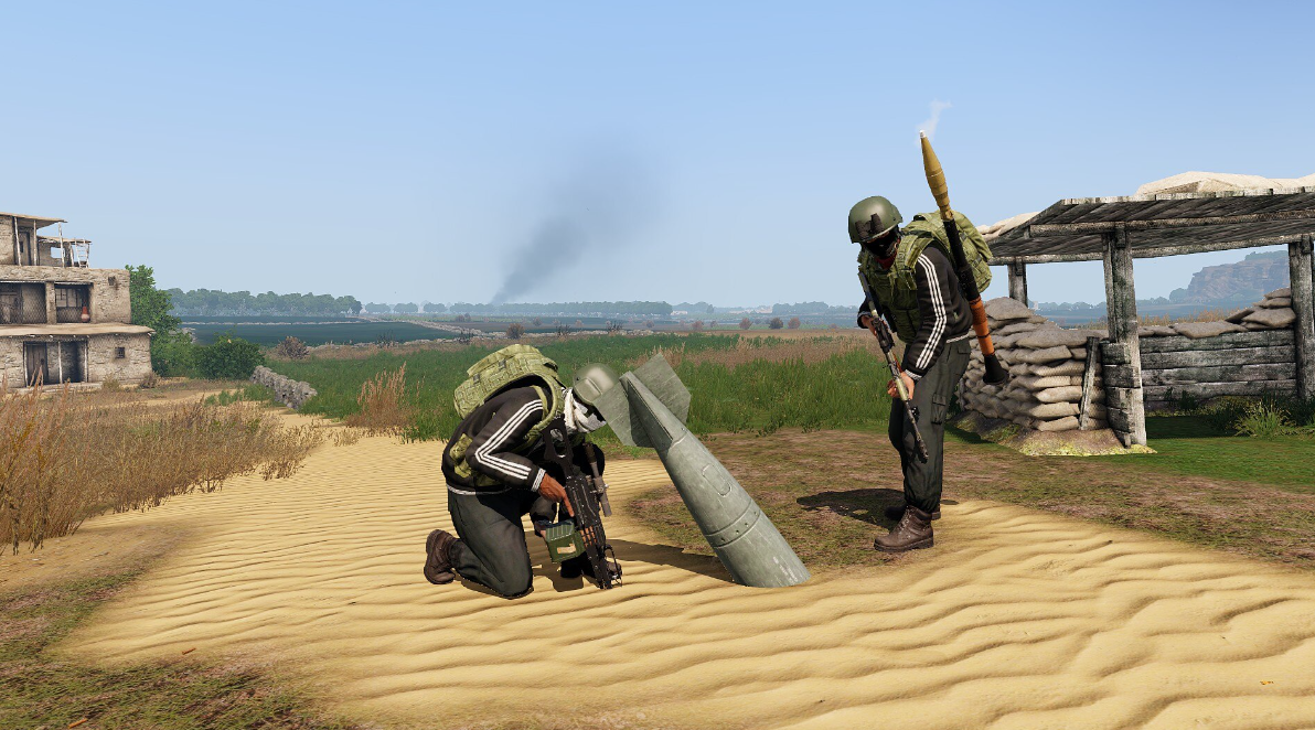 Two GFLAF fighters inspecting unexploded ordnance