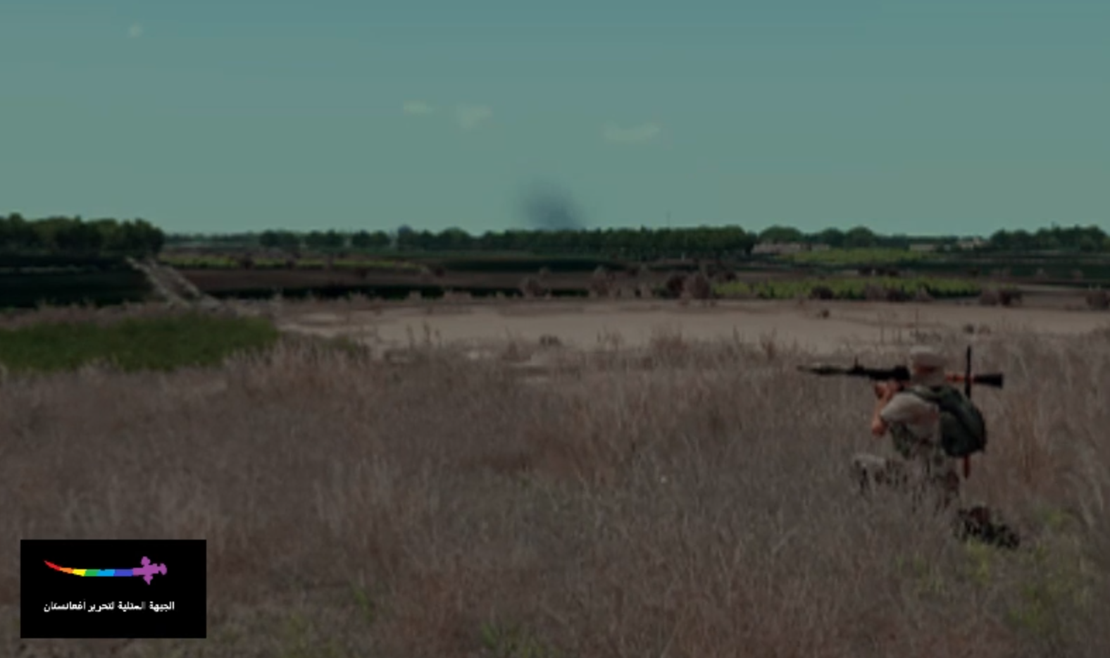 GFLAF fighter carrying an RPG across open ground