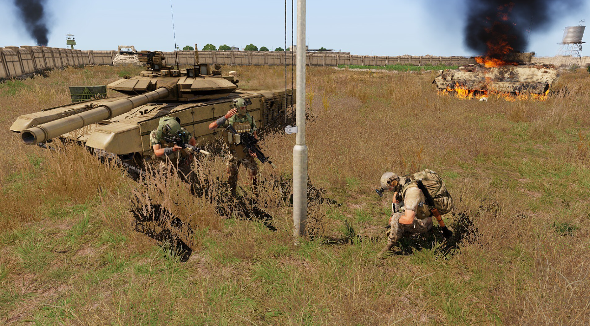 GFLAF fighters at the final enemy outpost beside captured and destroyed tanks